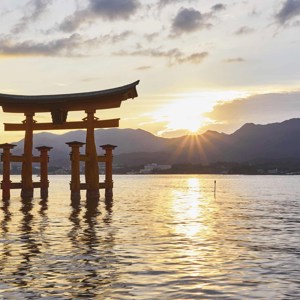 Torii gate at Itsukushima Shrine during sunset in Miyajima, Hiroshima, Japan