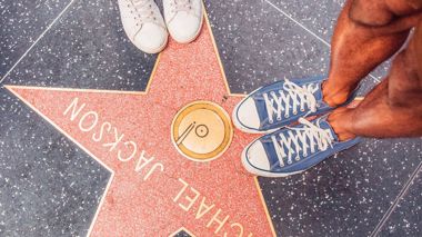Travellers stood on the Walk of Fame in Los Angeles, USA