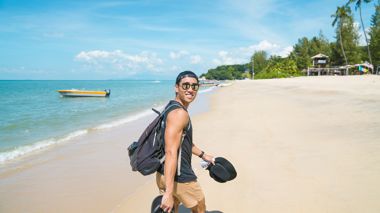 Traveller on the beach in Penang, Malaysia