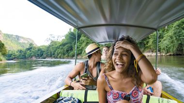 Travellers on a boat in Kanchanaburi, Thailand