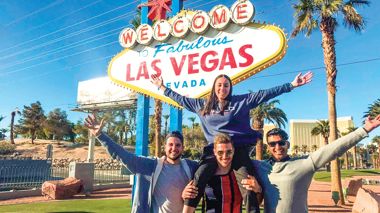 Group photo of Travellers in front of the sign at Las Vegas in the USA