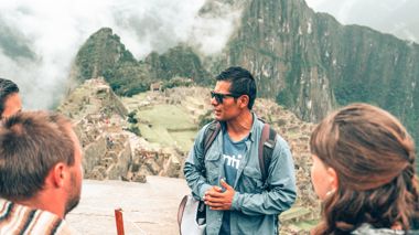 Local Guide with Travellers at Machu Picchu in Peru