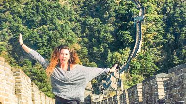 Traveller jumping on the Great Wall of China in Beijing, China