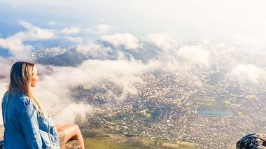 Traveller sat at Table Mountain in Cape Town, South Africa