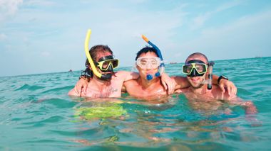 Travellers snorkelling the Great Barrier Reef in Cairns, Australia