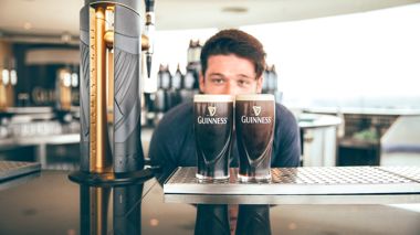 Traveller poured pints of Guinness at the Guinness Storehouse in Dublin, Ireland