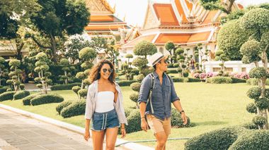 Travellers walking through the Grand Palace in Bangkok, Thailand