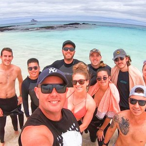 A group photo of Travellers at Tortuga Bay on Santa Cruz Island, Galapagos