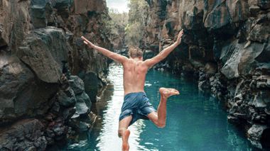 Traveller diving between the lava tunnels on Santa Cruz Island in the Galapagos
