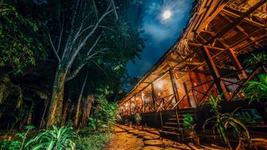 The exterior of the Jungle Lodge at night in Peru