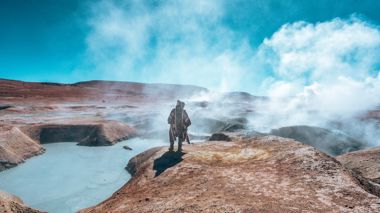 Traveller surrounded by steam in Avaroa National Reserve, Bolivia