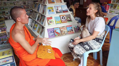 Traveller talking to a Monk in a classroom, Luang Prabang, Laos