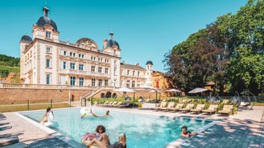 Travelers in swimming pool at Chateau De Cruix, in France