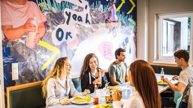 Travellers eating homecooked dinner at Haus Schoneck, Austria-