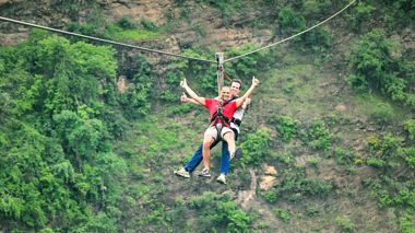 Travellers zipling across the gorge in Victoria Falls, Zimbabwe