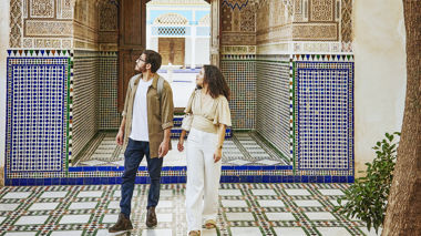 Two travellers walking through the Bahia Palace in Marrakesh, Morocco