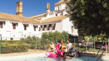 Travellers having fun in the pool at Hotel El Monasterio in Cordoba, Spain