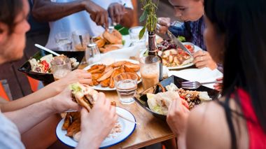 Travelers Tucking into Dinner at Table, Amsterdam, Netherlands