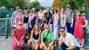 Travellers posing for a picture on a bridge, during a walking tour in Berlin, Germany