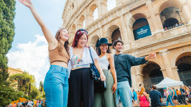 Travellers stood outside of the colosseum, Rome, Italy