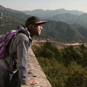 A traveller takes in sweeping views from the Great Wall of China on the Contiki Best of China Tour
