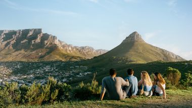 Travellers Sitting Together Looking at View of Table Mountain, Cape Town, South Africa