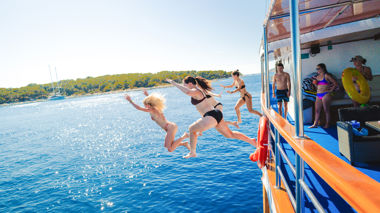 Travellers Jumping into the sea from the sail boat en route to Hvar, Croatia