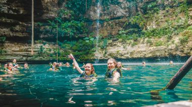 Travellers Swimming in Cenote in Life Jackets, Chichen Itza, Mexico