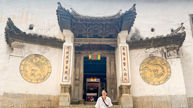 Traveller sat on the steps outside the H'Mong Palace, Ha Giang Loop, Vietnam