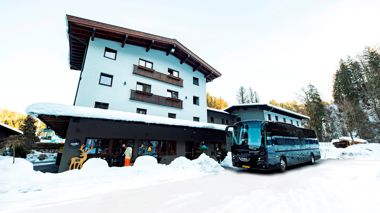 Travellers laughing in the snow in the town of Hopfgarten, Austria