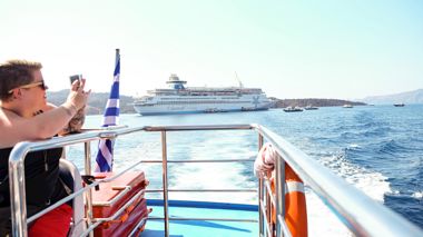 Traveller taking a photo during the ferry ride from Athens, Greece.