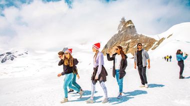 Travellers walking at the top of the Jungfrau Mountain in Lauterbrunnen, Switzerland