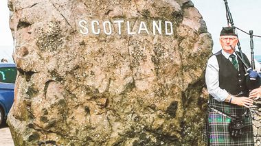 Bagpiper player at the border of England and Scotland in the UK