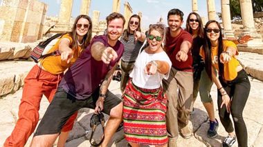 Travellers pointing at the camera in Jerash, Jordan