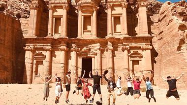 Travellers jumping at Petra in Jordan