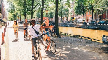 Cycling past Canals in Amsterdam, Netherlands