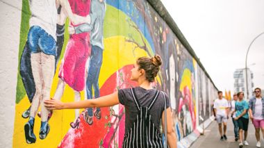 Traveller walking down the East Side Gallery in Berlin, Germany
