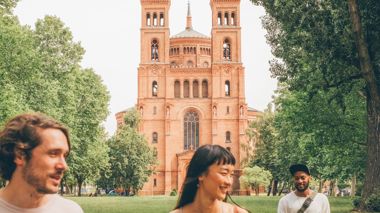 Travellers outside St. Thomas Church in Berlin, Germany