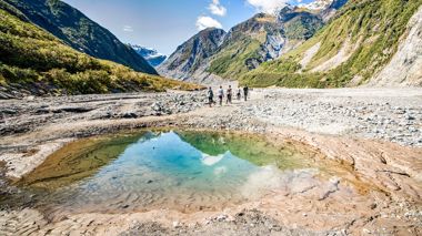 Travelers Hiking Fox Glacier Valley, New Zealand