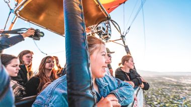Travellers Looking out over Land from Hot Air Balloon, Albuquerque, USA