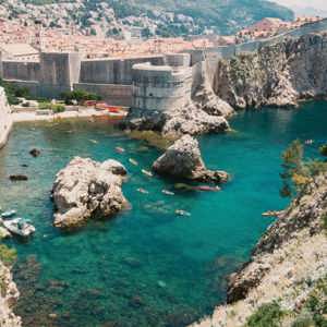 Crystal-clear turquoise waters meet the medieval walls of Dubrovnik on the Contiki Best of Balkans Tour