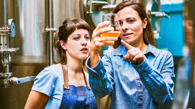 Travellers observing beer in the brewery