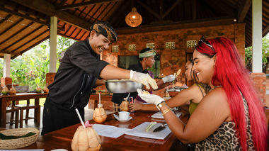 Travellers learning how to cook Balinese food with locals in Ubud, Indonesia