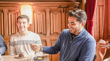 Two travellers sitting at a table enjoying dinner in Amsterdam, Netherlands