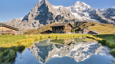 View of Jungfrau behind lake and Alpine buildings, Switzerland