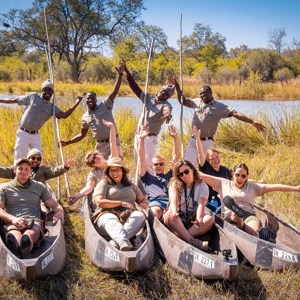 Travellers enjoying a poling boat ride on the Okavango Delta