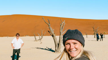 Travellers stood near the old trees of Deadvlei, Namibia
