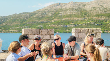 Travellers sat at a table in Korčula town, Croatia