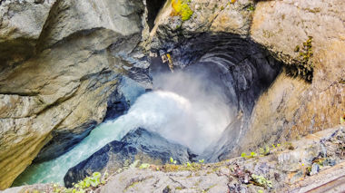 Aerial view of waterfall flowing into canyon, Lauterbrunnen, Switzerland