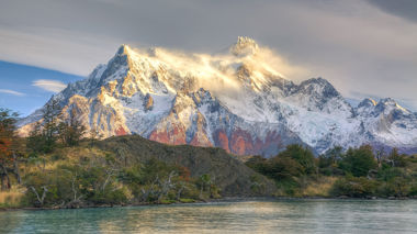Landscape view of snowy mountains set behind a lake in Puerto Natales, Patagonia